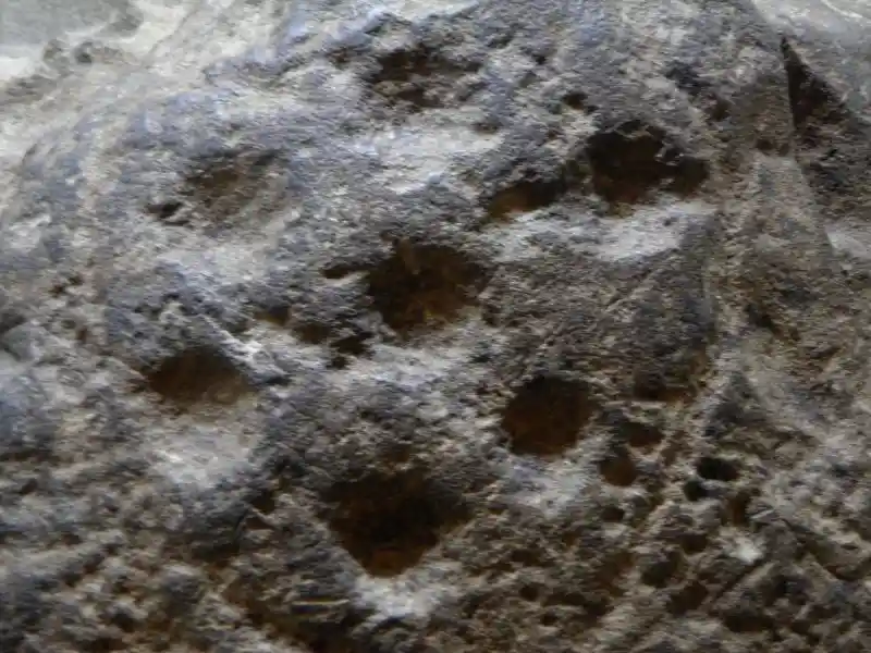 Solar disc sith a six-pointed symbol on a stone